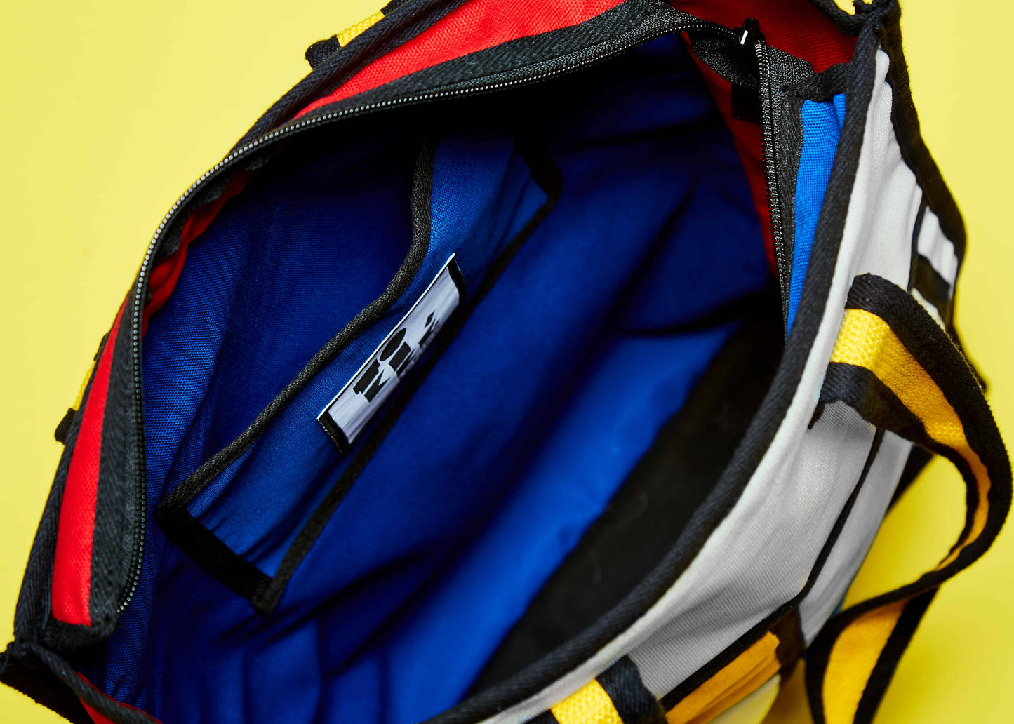 Elevate Your Style with Kilte Tote Bag - A Chic Fashion Statement.   A lifestyle shot featuring the Kilte tote bag, a chic fashion statement that elevates your style. Its Piet Mondrian-inspired colorblock art adds an element of sophistication to any outfit, making it a standout accessory