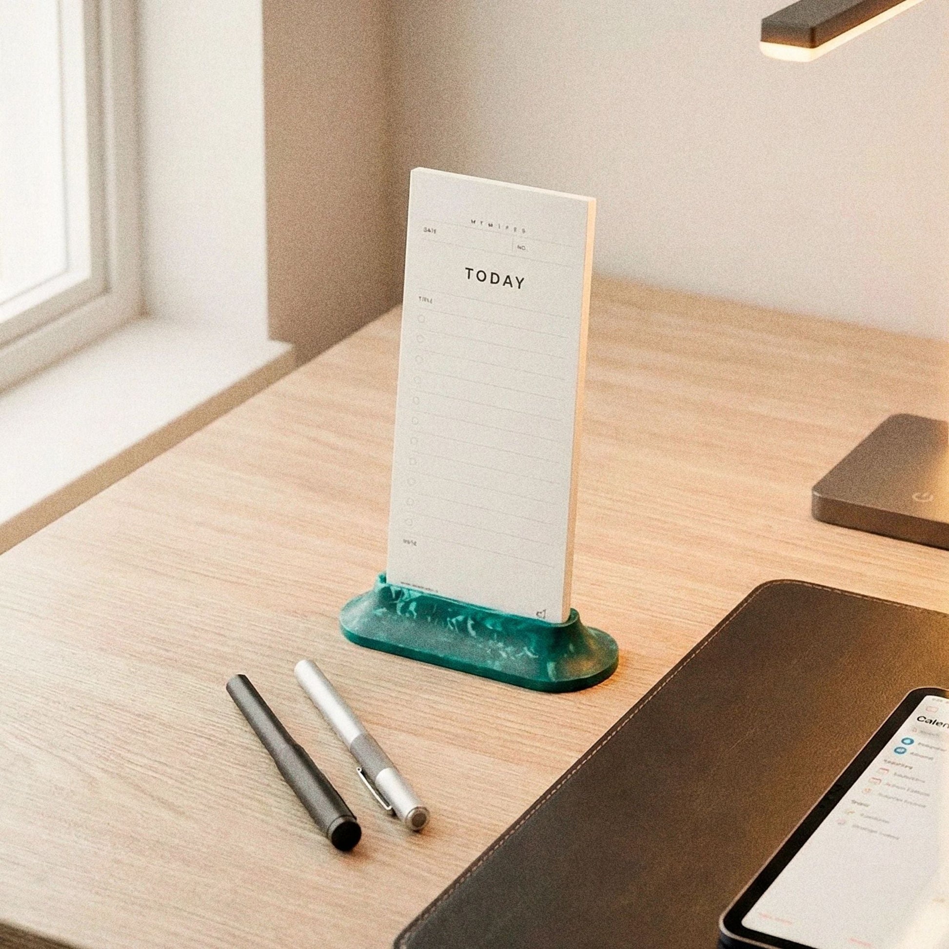 Aero Task Dock on a wooden desk showing eco-friendly Jesmonite construction and cork base
