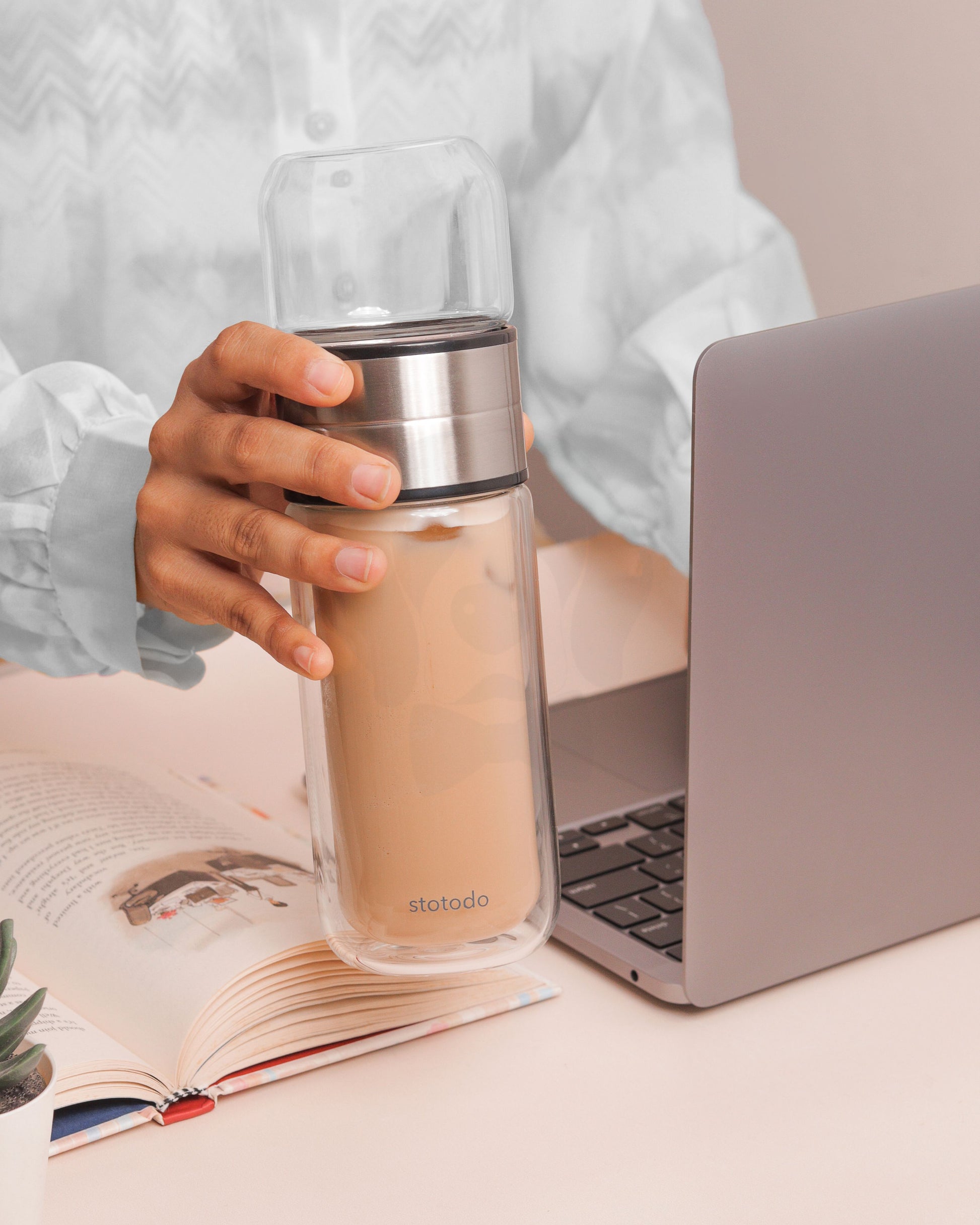 Lady Using Brewski to Drink Coffee While Working