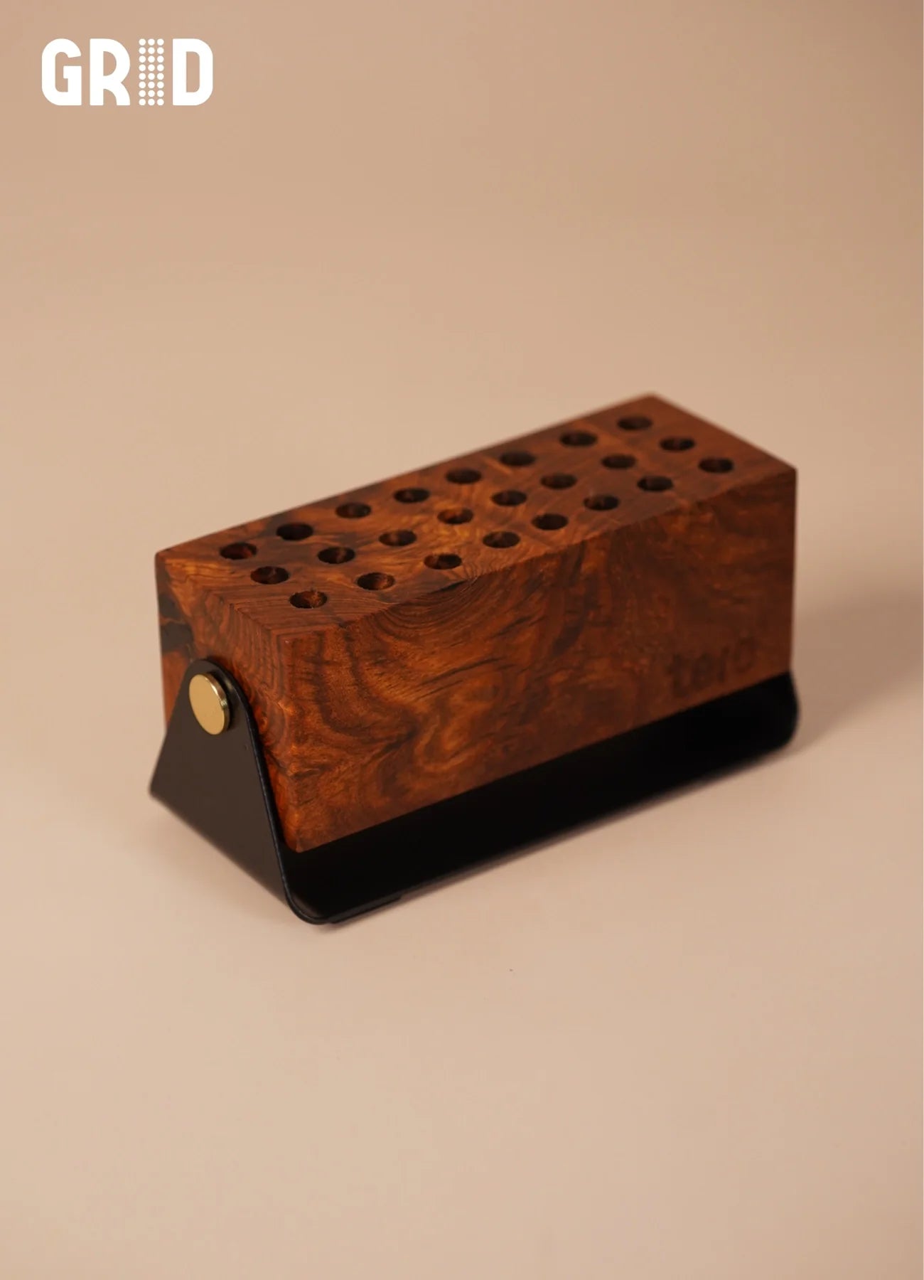 GRID solid wood pen holder side view showing tilt-adjustable matte black base and Sheesham grain