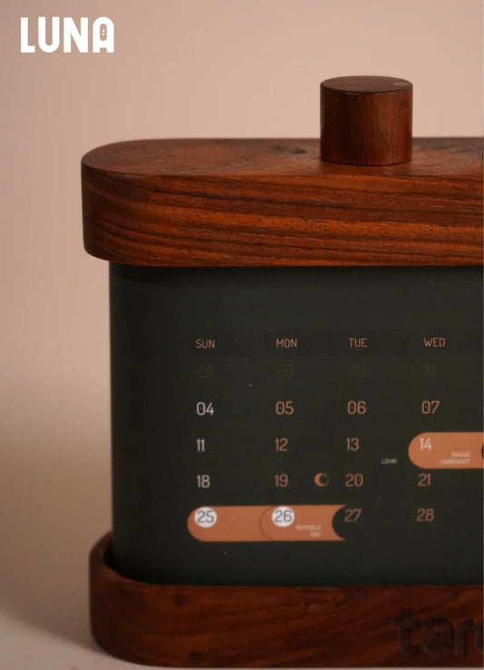 LUNA 2026 solid wood rotating desk calendar showing monthly scroll mechanism on a desk
